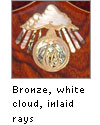 Bronze inlaid logo with rays